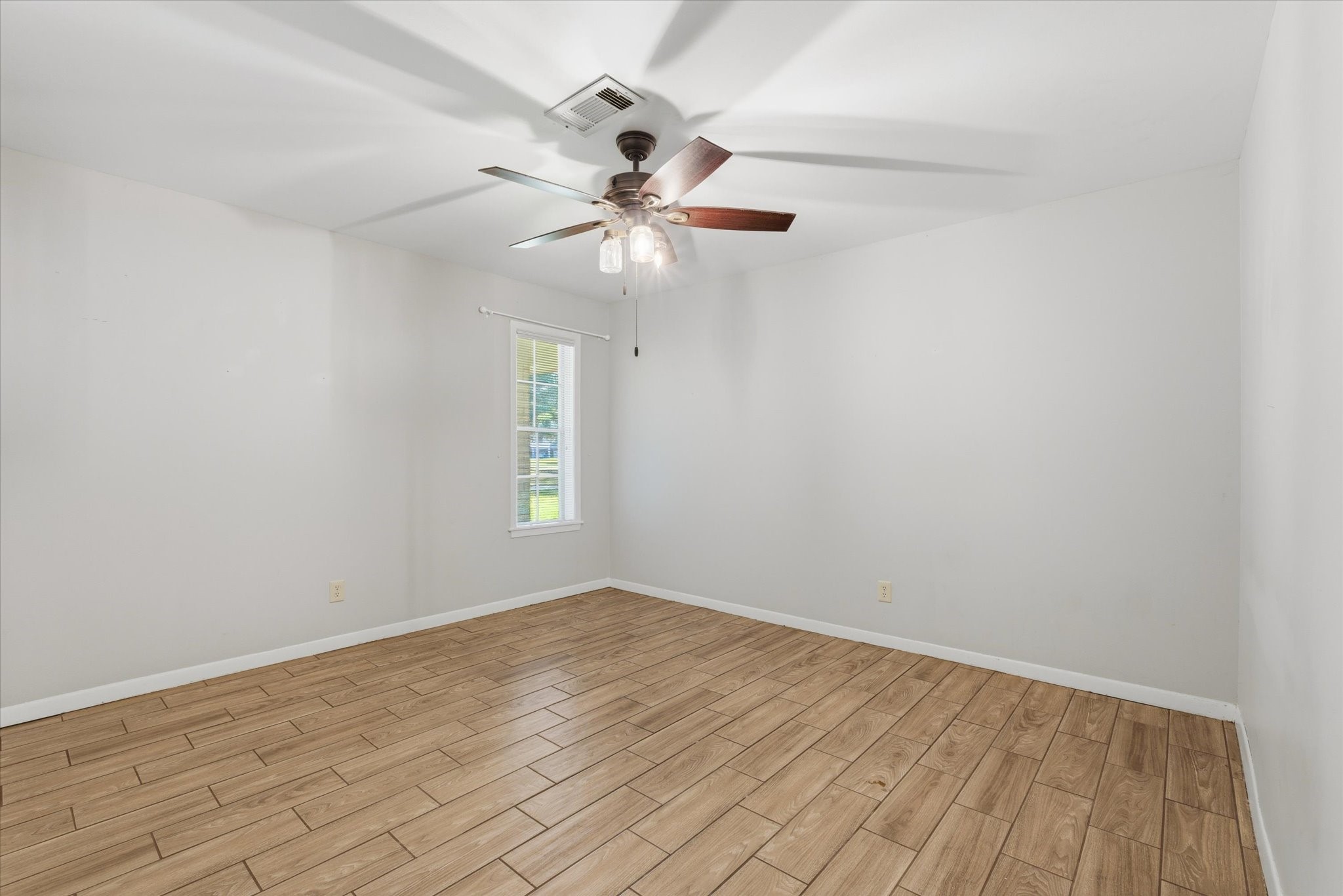 6004 Lakeside Drive Liberty, TX 77575 - Photo 20 of 28 wooden floor in an empty room with a window