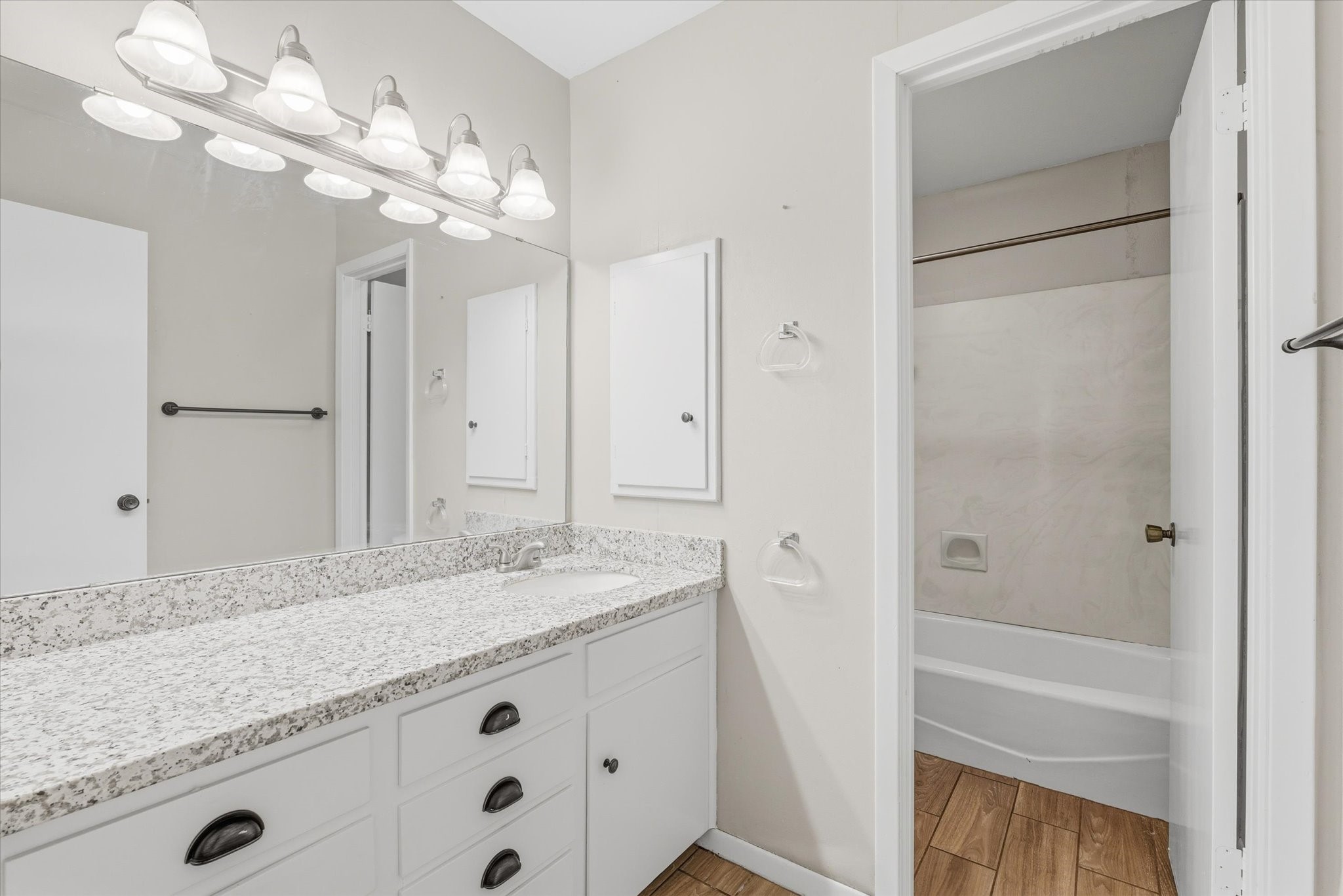 6004 Lakeside Drive Liberty, TX 77575 - Photo 21 of 28 a bathroom with a granite countertop sink a mirror and a shower