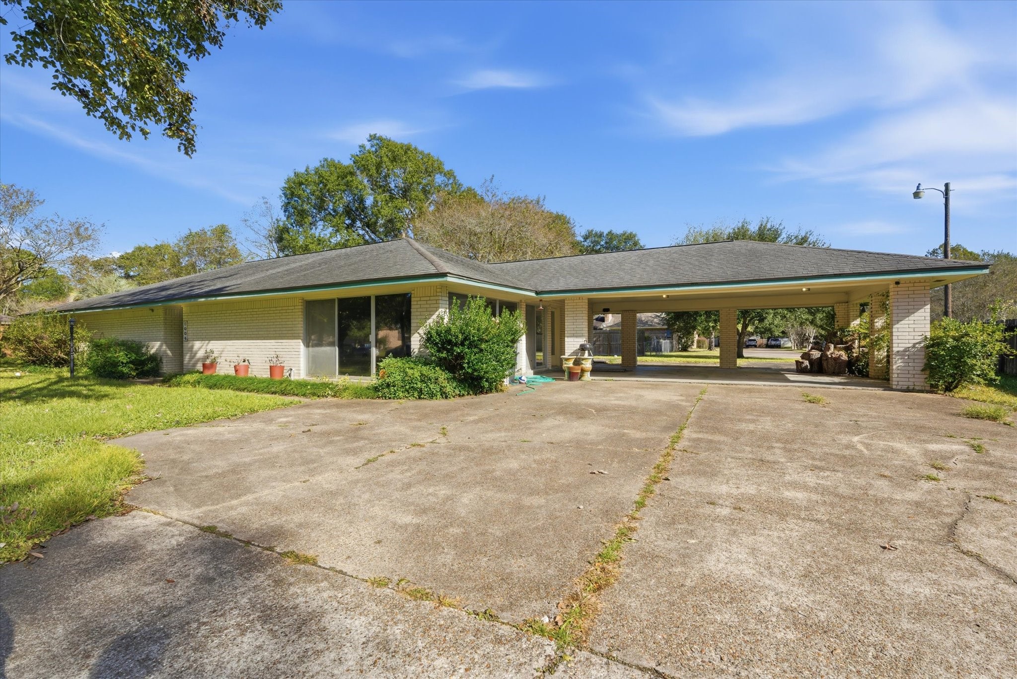 6004 Lakeside Drive Liberty, TX 77575 - Photo 27 of 28 a front view of a house with a yard and potted plants