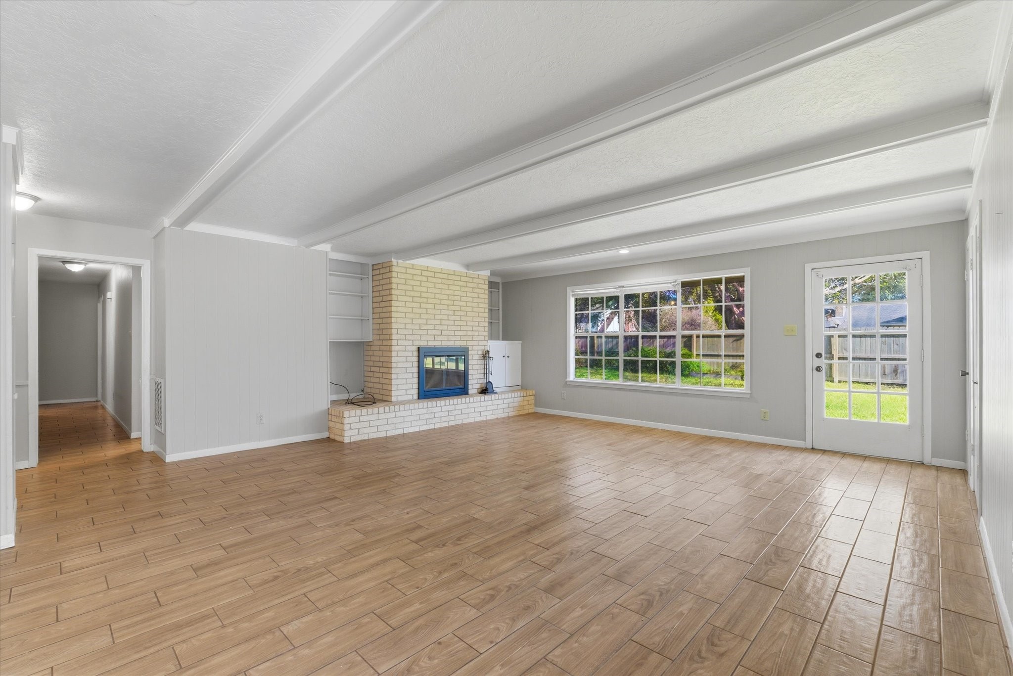 6004 Lakeside Drive Liberty, TX 77575 - Photo 4 of 28 a view of an empty room with a window and wooden floor