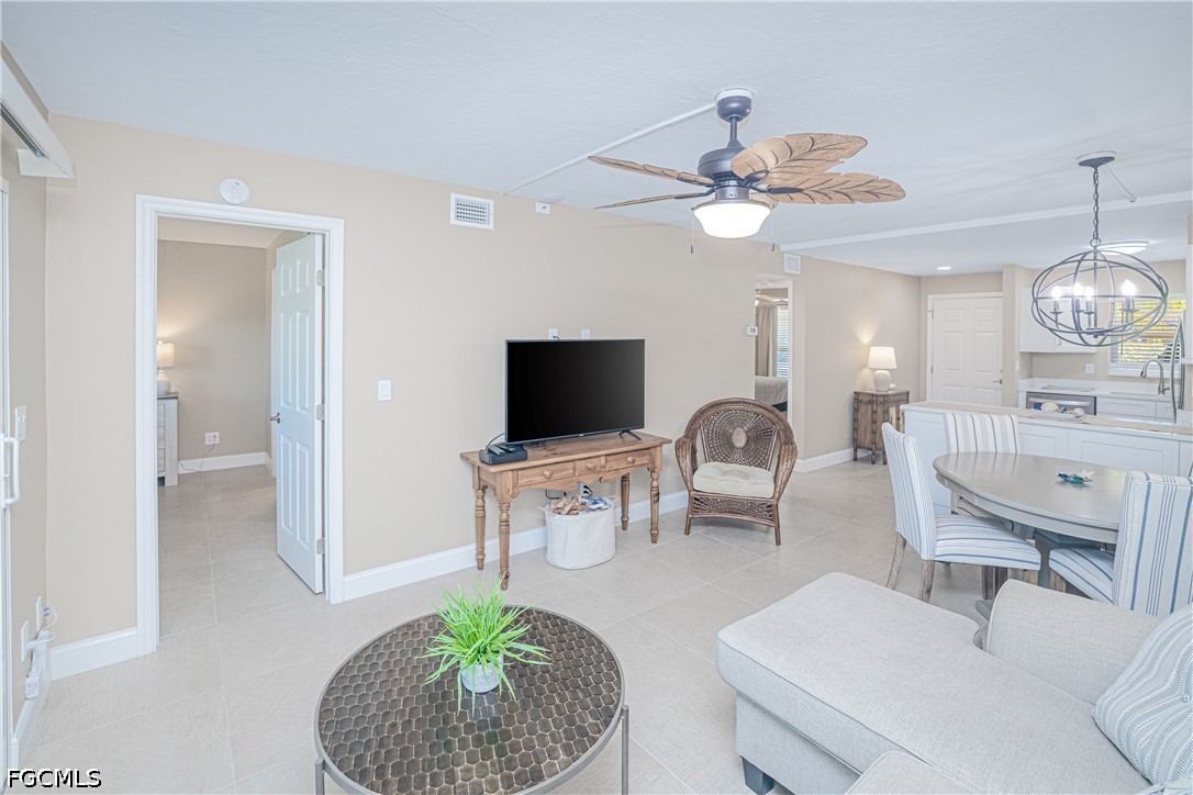 16007 Davis Road, Unit 713 Fort Myers, FL 33908 - Photo 12 of 41 a living room with furniture a flat screen tv and a large window