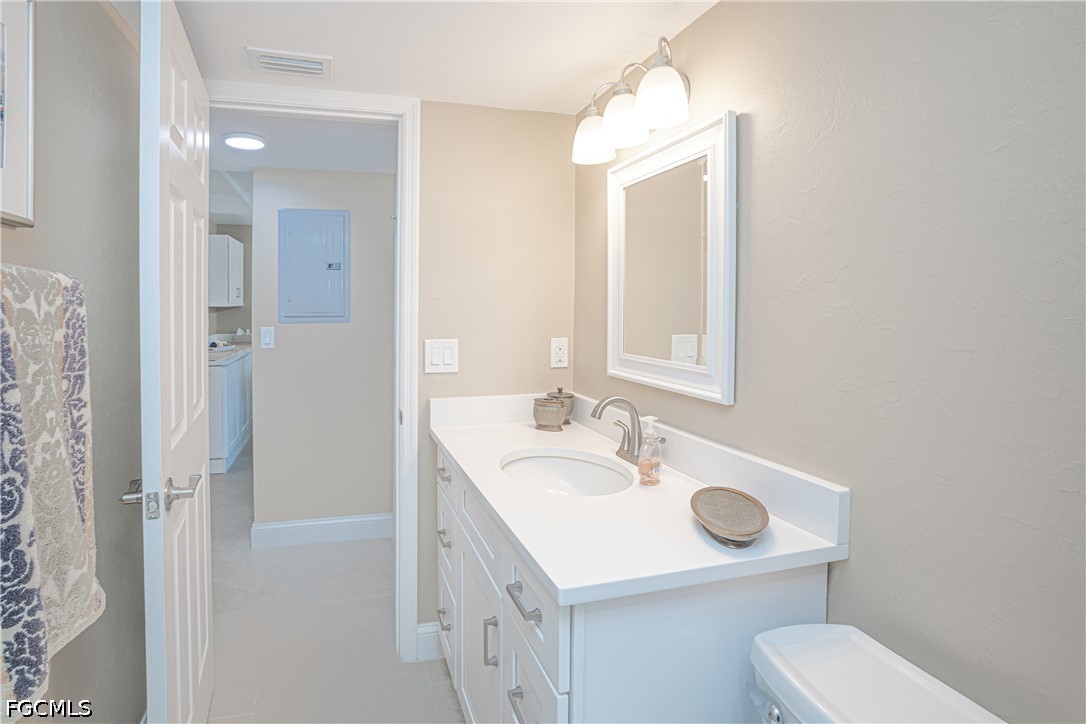 16007 Davis Road, Unit 713 Fort Myers, FL 33908 - Photo 15 of 41 a bathroom with a sink toilet and mirror