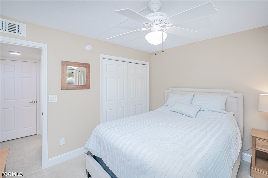 16007 Davis Road, Unit 713 Fort Myers, FL 33908 - Photo 17 of 41 a bedroom with a large bed and a chandelier