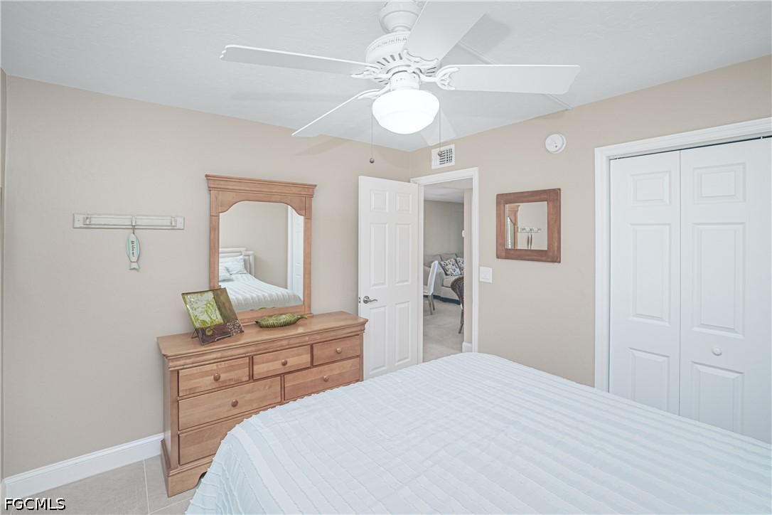 16007 Davis Road, Unit 713 Fort Myers, FL 33908 - Photo 18 of 41 a bedroom with a bed and a chandelier