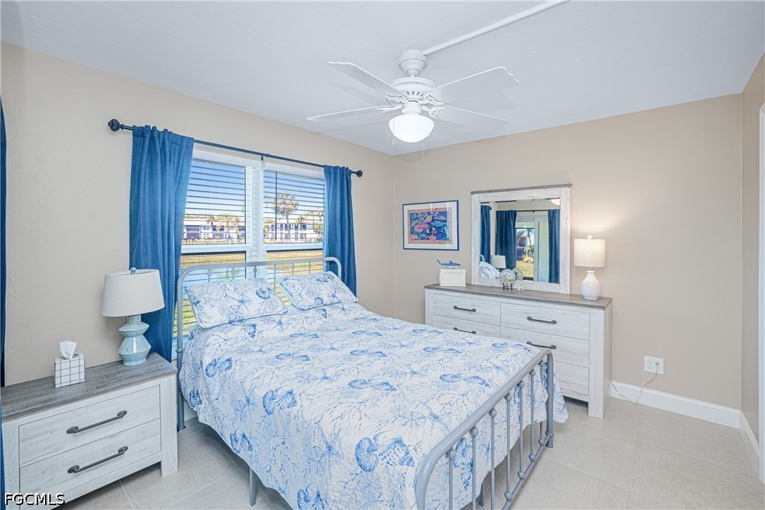 16007 Davis Road, Unit 713 Fort Myers, FL 33908 - Photo 19 of 41 a bedroom with a bed and a dresser