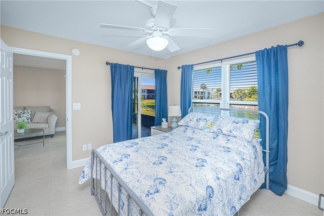 16007 Davis Road, Unit 713 Fort Myers, FL 33908 - Photo 20 of 41 a bedroom with a large bed and a chandelier