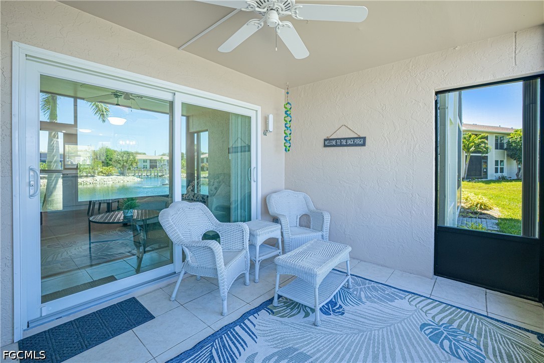 16007 Davis Road, Unit 713 Fort Myers, FL 33908 - Photo 27 of 41 a living room with furniture and a floor to ceiling window