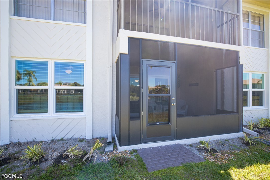 16007 Davis Road, Unit 713 Fort Myers, FL 33908 - Photo 29 of 41 a front view of a house with a yard