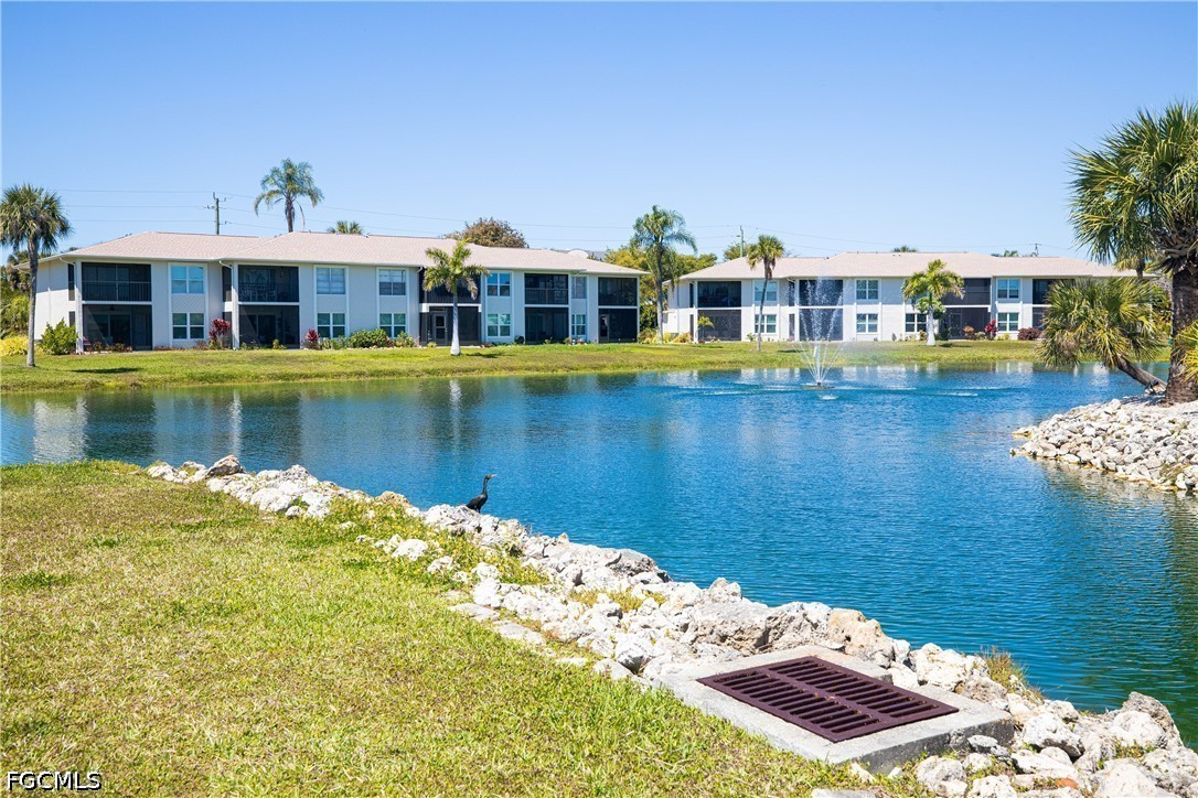16007 Davis Road, Unit 713 Fort Myers, FL 33908 - Photo 33 of 41 a front view of a house with a lake view