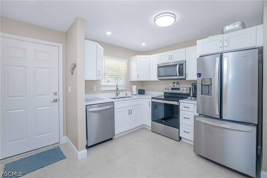 16007 Davis Road, Unit 713 Fort Myers, FL 33908 - Photo 5 of 41 a kitchen with a refrigerator stove and microwave