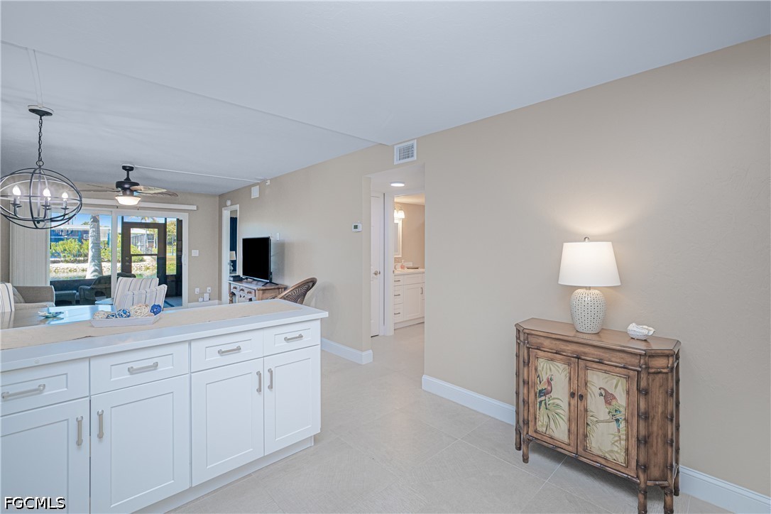 16007 Davis Road, Unit 713 Fort Myers, FL 33908 - Photo 6 of 41 a spacious bathroom with a sink a light fixture and a mirror