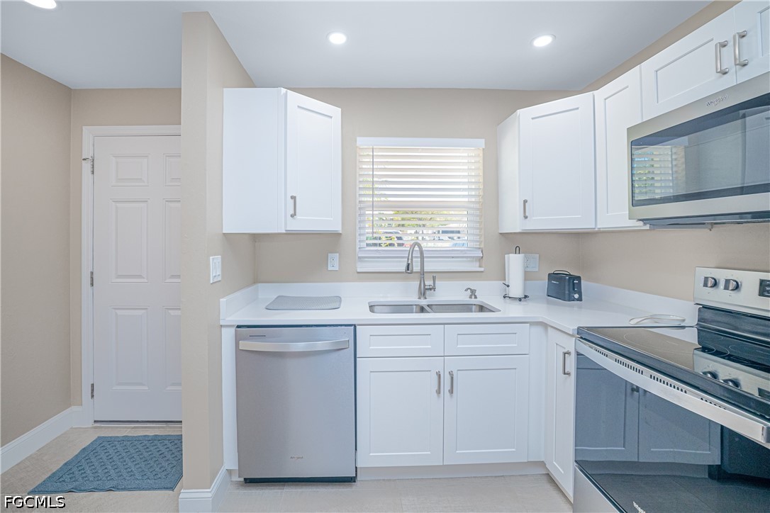 16007 Davis Road, Unit 713 Fort Myers, FL 33908 - Photo 7 of 41 a kitchen with a sink stove and microwave