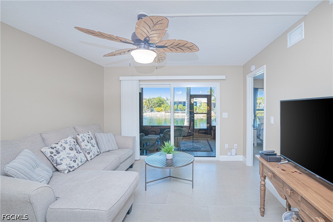16007 Davis Road, Unit 713 Fort Myers, FL 33908 - Photo 10 of 41 a living room with furniture and a flat screen tv