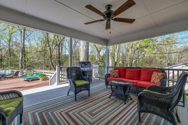 a living room with furniture and a floor to ceiling window