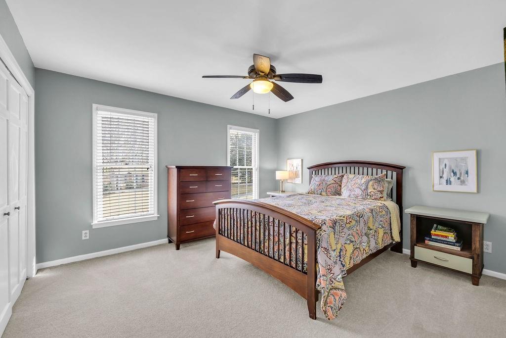 7650 Ryefield Drive Sandy Springs, GA 30350 - Photo 24 of 38 a bedroom with a bed and a ceiling fan