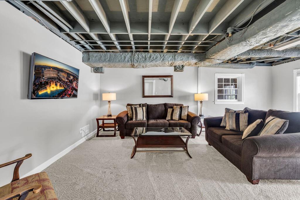 7650 Ryefield Drive Sandy Springs, GA 30350 - Photo 30 of 38 a living room with furniture and a chandelier