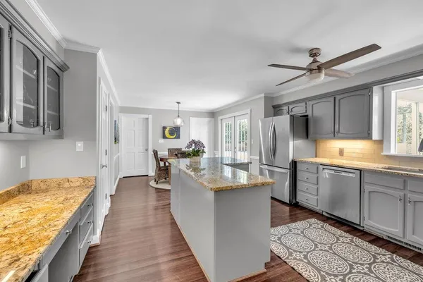 a kitchen with counter top space cabinets appliances and windows