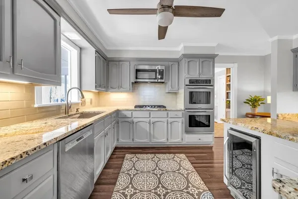 a kitchen with stainless steel appliances granite countertop a sink and stove top oven