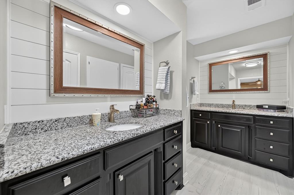 47 Bounty Road East Benbrook, TX 76132 - Photo 18 of 39 Dual vanity bathroom featuring granite countertops and dark wood cabinetry