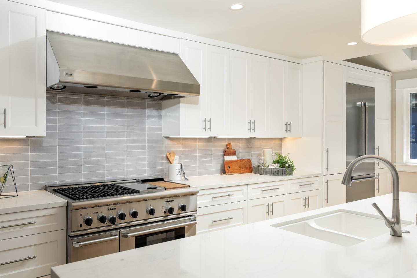 153 Stone Pine Lane Menlo Park, CA 94025 - Photo 9 of 31 a kitchen with stainless steel appliances a stove and cabinets