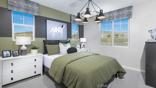 a bed room with a bed mirror and a window