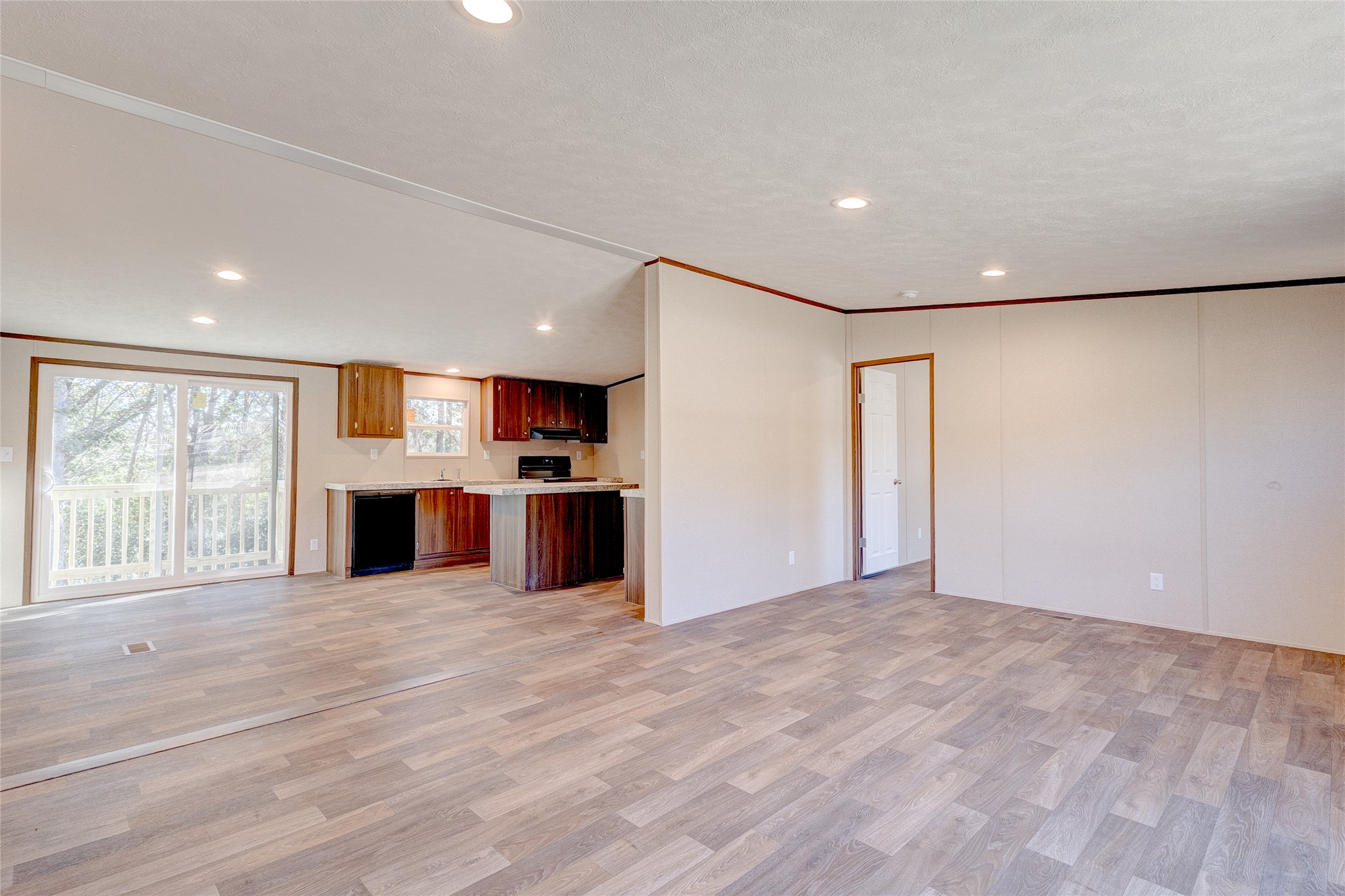 107 Los Cueva Road Elgin, TX 78621 - Photo 23 of 31 Unfurnished living room with crown molding, light wood finished floors, and recessed lighting