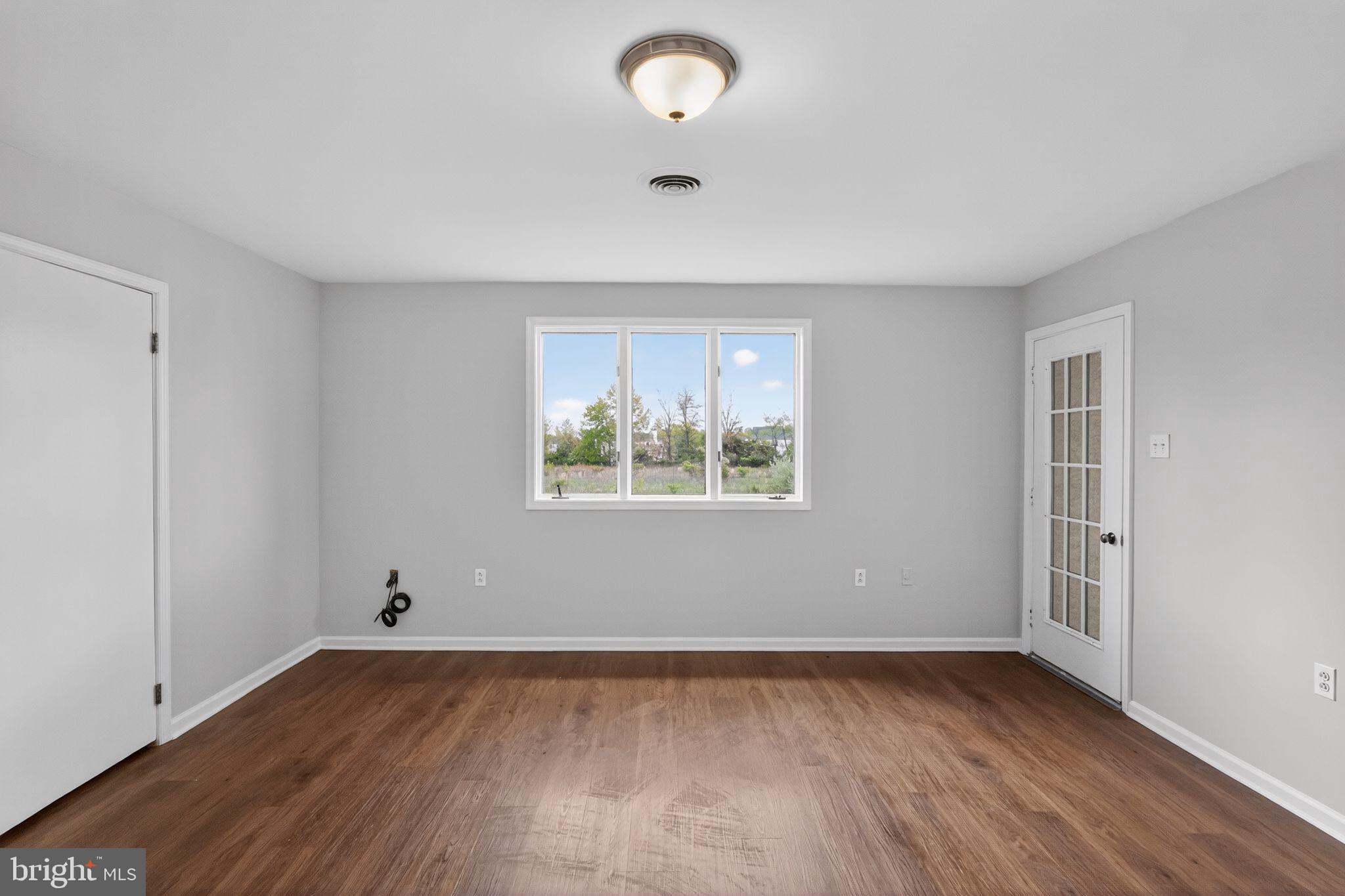 26 Sunset Road Royersford, PA 19468 - Photo 16 of 30 wooden floor in an empty room with a window