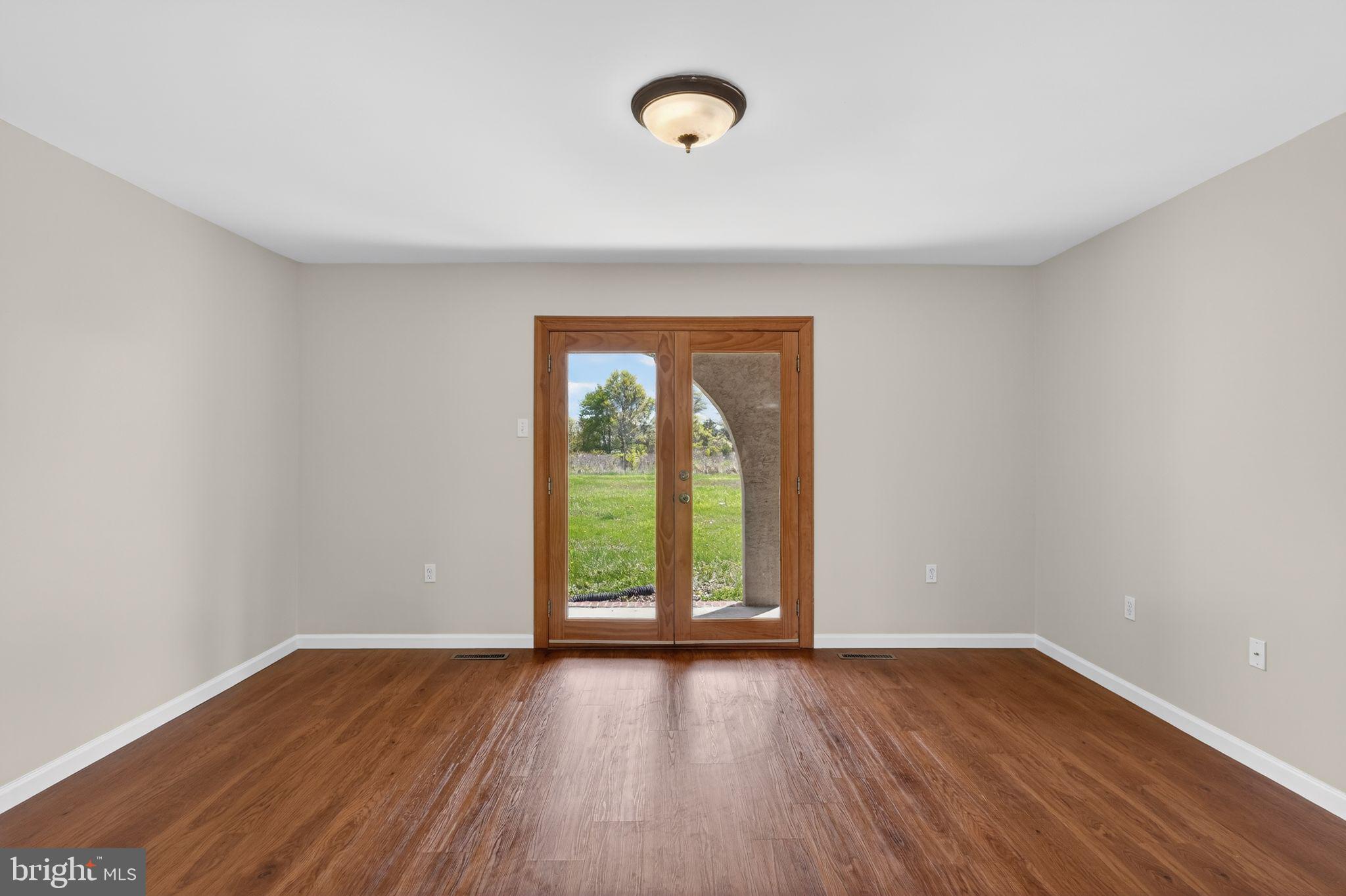 26 Sunset Road Royersford, PA 19468 - Photo 7 of 30 an empty room with wooden floor and windows