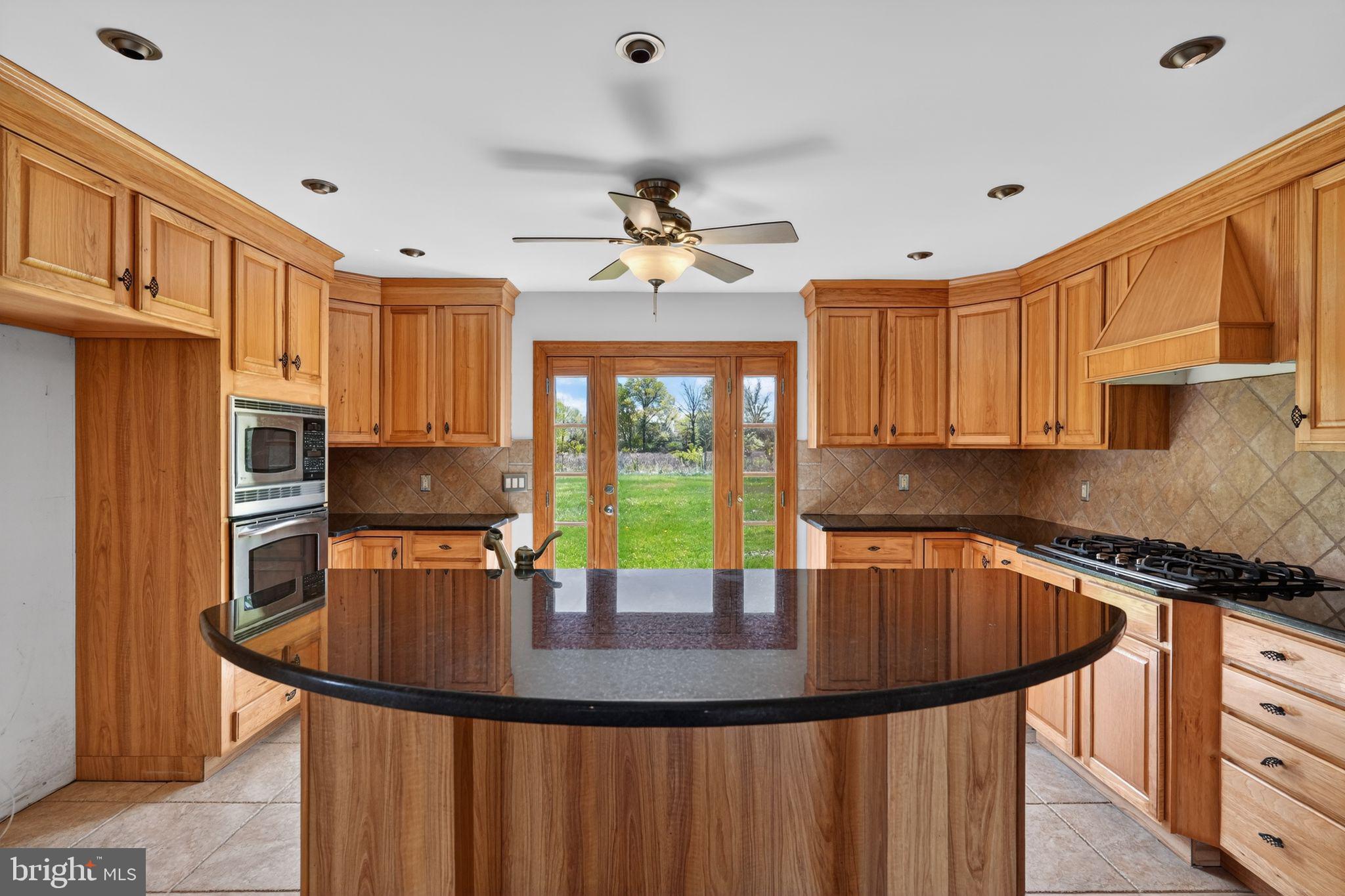 26 Sunset Road Royersford, PA 19468 - Photo 10 of 30 a kitchen with stainless steel appliances granite countertop a sink a stove a refrigerator a center island and furniture