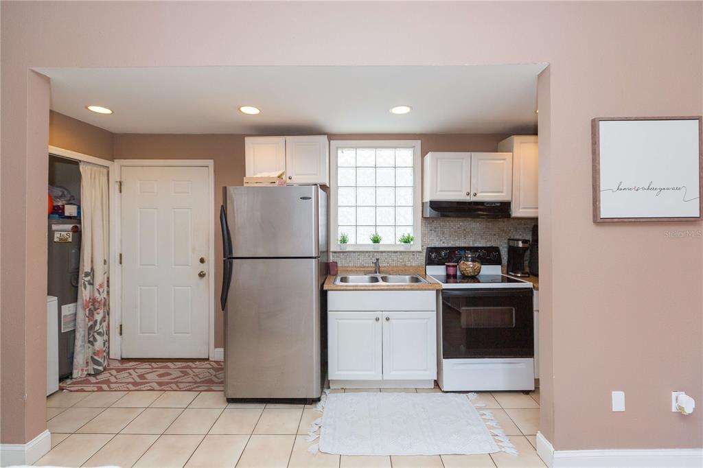 2322 West Cherry Street Tampa, FL 33607 - Photo 21 of 36 a kitchen with a refrigerator a stove top oven and a sink