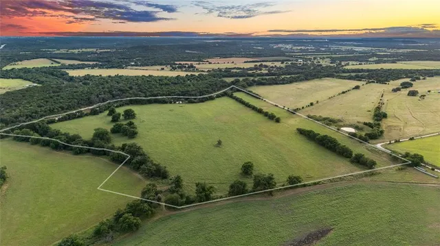 an aerial view of residential houses with outdoor space and ocean view
