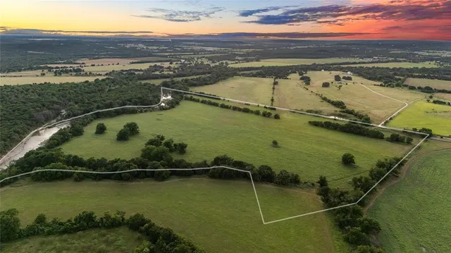an aerial view of residential houses with outdoor space and river