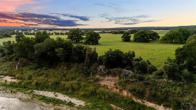 a view of a lake and green valley