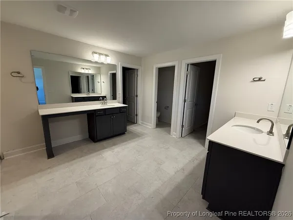 a view of kitchen with stainless steel appliances kitchen island a sink dishwasher a stove and a refrigerator with wooden floor