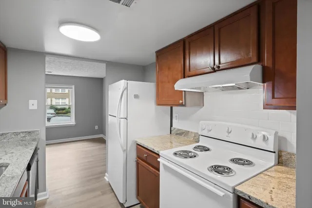 a kitchen with a stove and a refrigerator