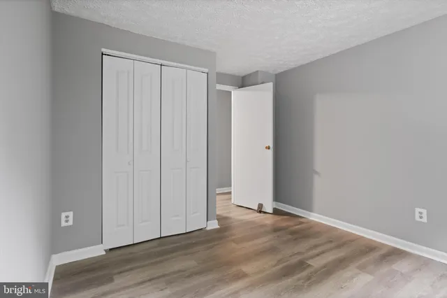 a view of an empty room and wooden floor