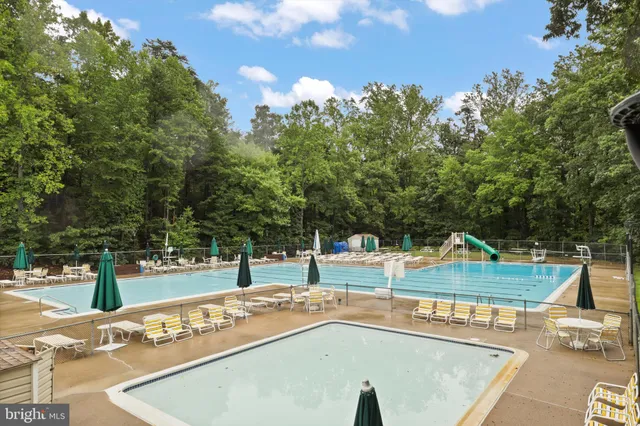 a view of a swimming pool with an outdoor seating