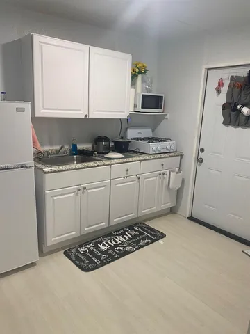a kitchen with a sink stove and refrigerator