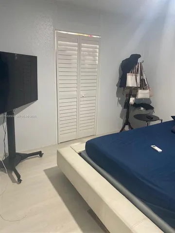 a room with a bed and a flat screen tv