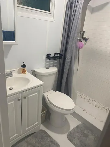 a white toilet sitting next to a bathroom sink