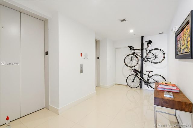 a view of a hallway with front door wooden floor