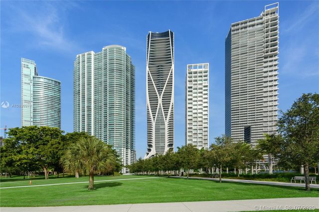 a front view of a building with a yard