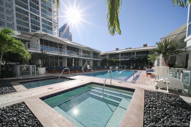 a view of a house with swimming pool and sitting area