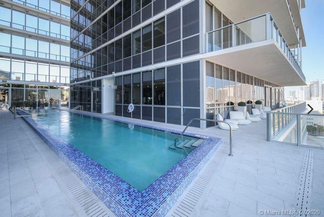 a view of a swimming pool with outdoor seating