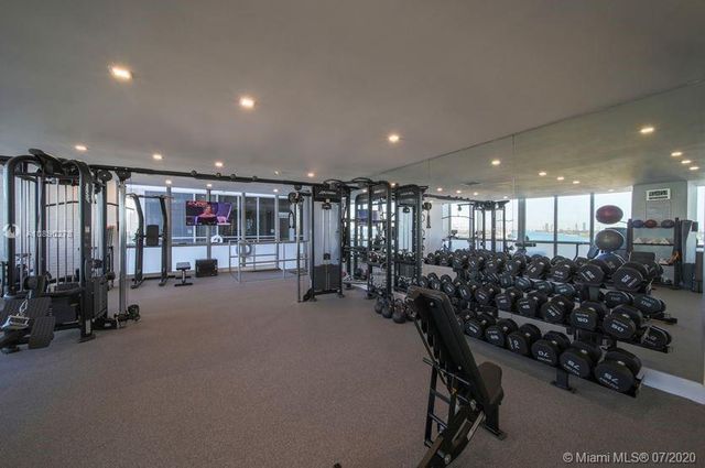 a room with gym equipment and lots of gym equipment