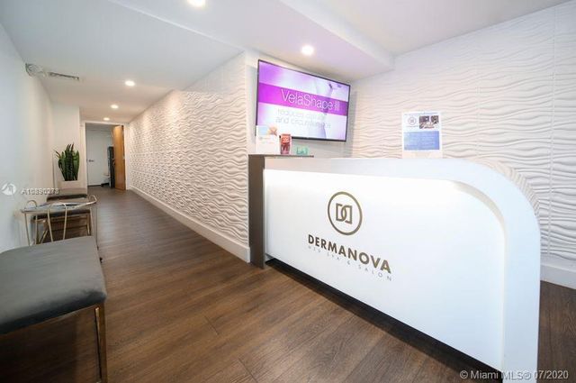 a view of a kitchen with stainless steel appliances granite countertop a stove and a refrigerator