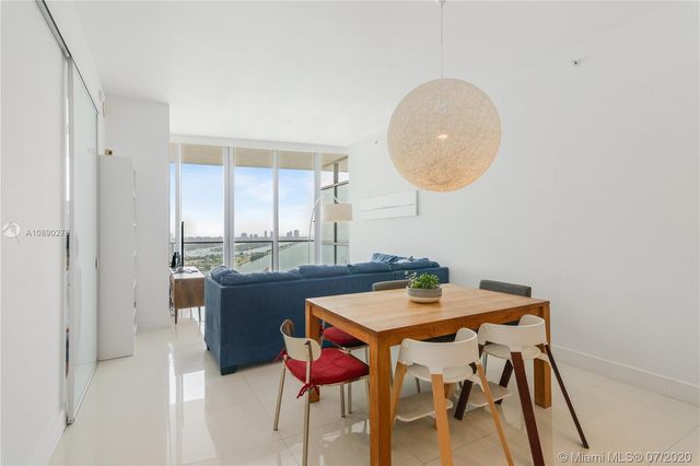 a view of a dining room with furniture and window