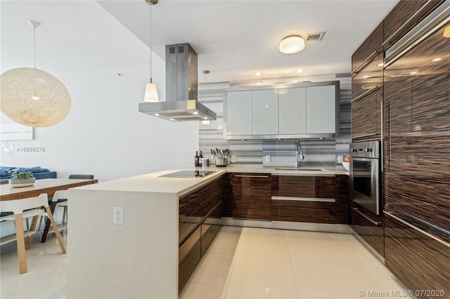 a kitchen that has a sink and a stove