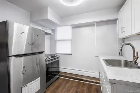 a kitchen with a refrigerator and a sink
