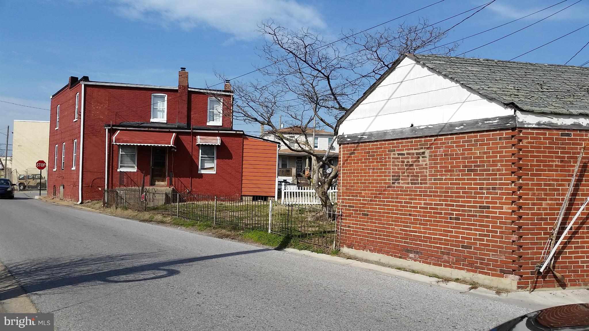 6501 Baltimore Avenue Baltimore, MD 21222 - Photo 2 of 21 a view of a brick house with many windows